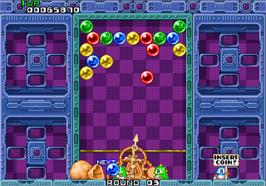 In game image of Puzzle Bobble on the Arcade.