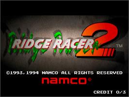 Title screen of Ridge Racer 2 on the Arcade.