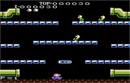 In game image of Mario Bros. on the Atari 7800.