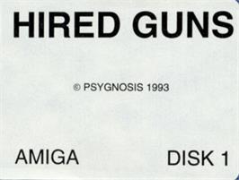 Top of cartridge artwork for Hired Guns on the Commodore Amiga.