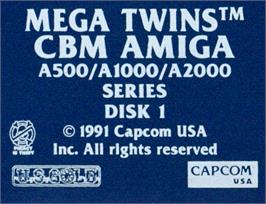 Top of cartridge artwork for Mega Twins on the Commodore Amiga.