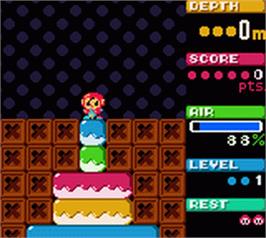 In game image of Mr Driller on the Nintendo Game Boy Color.