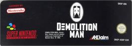 Top of cartridge artwork for Demolition Man on the Nintendo SNES.