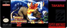 Top of cartridge artwork for King of the Monsters 2: The Next Thing on the Nintendo SNES.