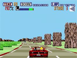 In game image of Out Run on the Sega Genesis.