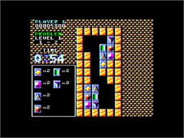In game image of Puzznic on the Amstrad CPC.
