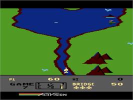 In game image of River Raid on the Atari 8-bit.