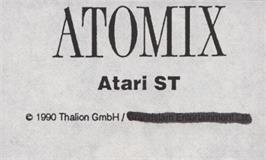 Top of cartridge artwork for Atomix on the Atari ST.