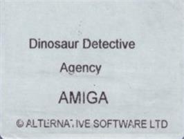 Top of cartridge artwork for Dinosaur Detective Agency on the Commodore Amiga.