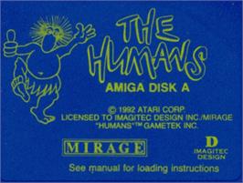 Top of cartridge artwork for Humans, The on the Commodore Amiga.