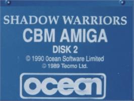 Top of cartridge artwork for Shadow Warriors on the Commodore Amiga.