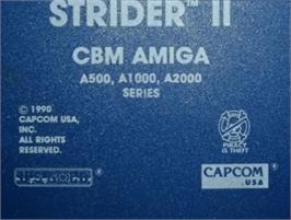 Top of cartridge artwork for Strider 2 on the Commodore Amiga.