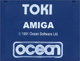 Top of cartridge artwork for Toki: Going Ape Spit on the Commodore Amiga.