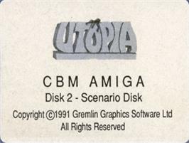 Top of cartridge artwork for Utopia: The Creation of a Nation on the Commodore Amiga.