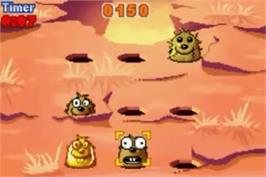 In game image of Whac-a-mole on the Nintendo Game Boy Advance.