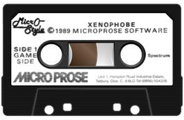 Cartridge artwork for Xenophobe on the Sinclair ZX Spectrum.